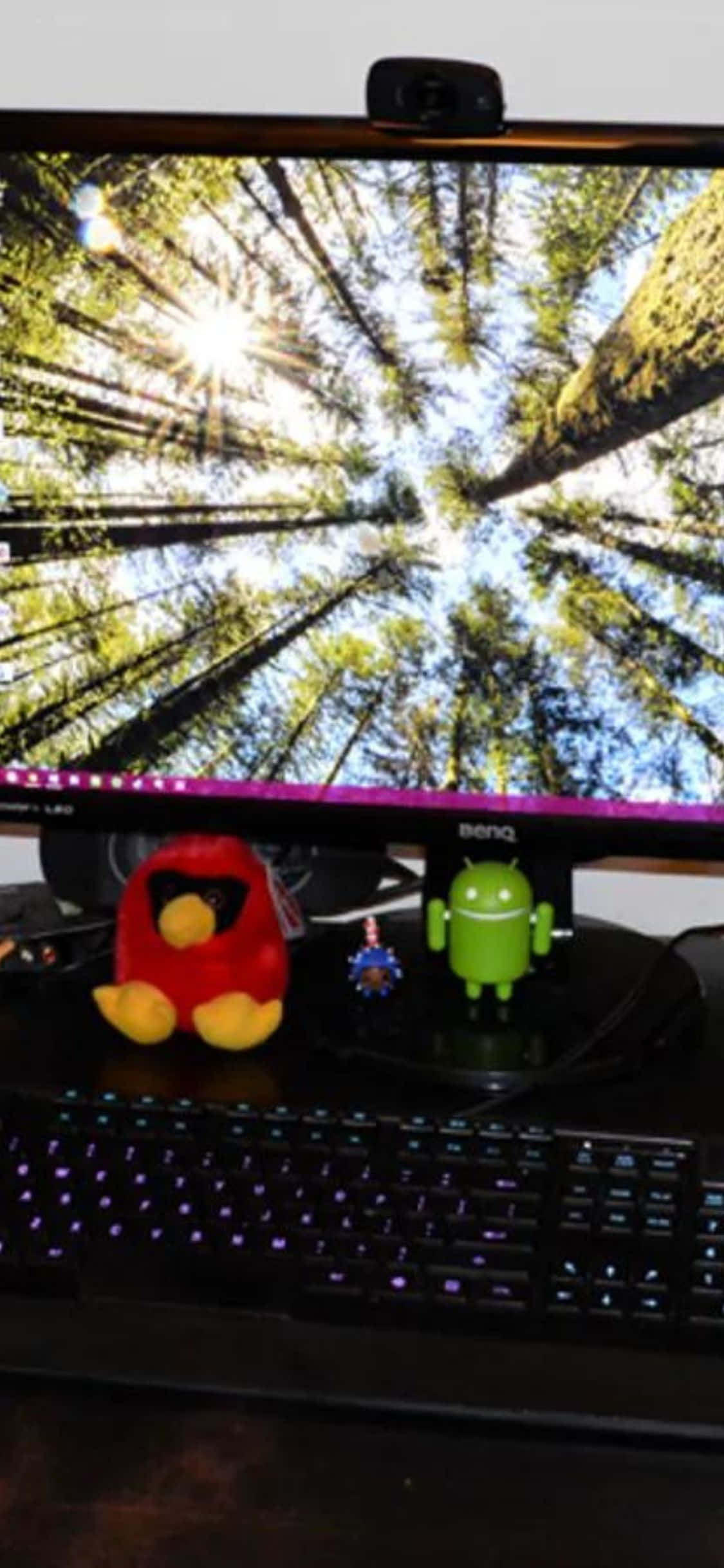 isang computer monitor ay nasa isang mesa Wallpaper