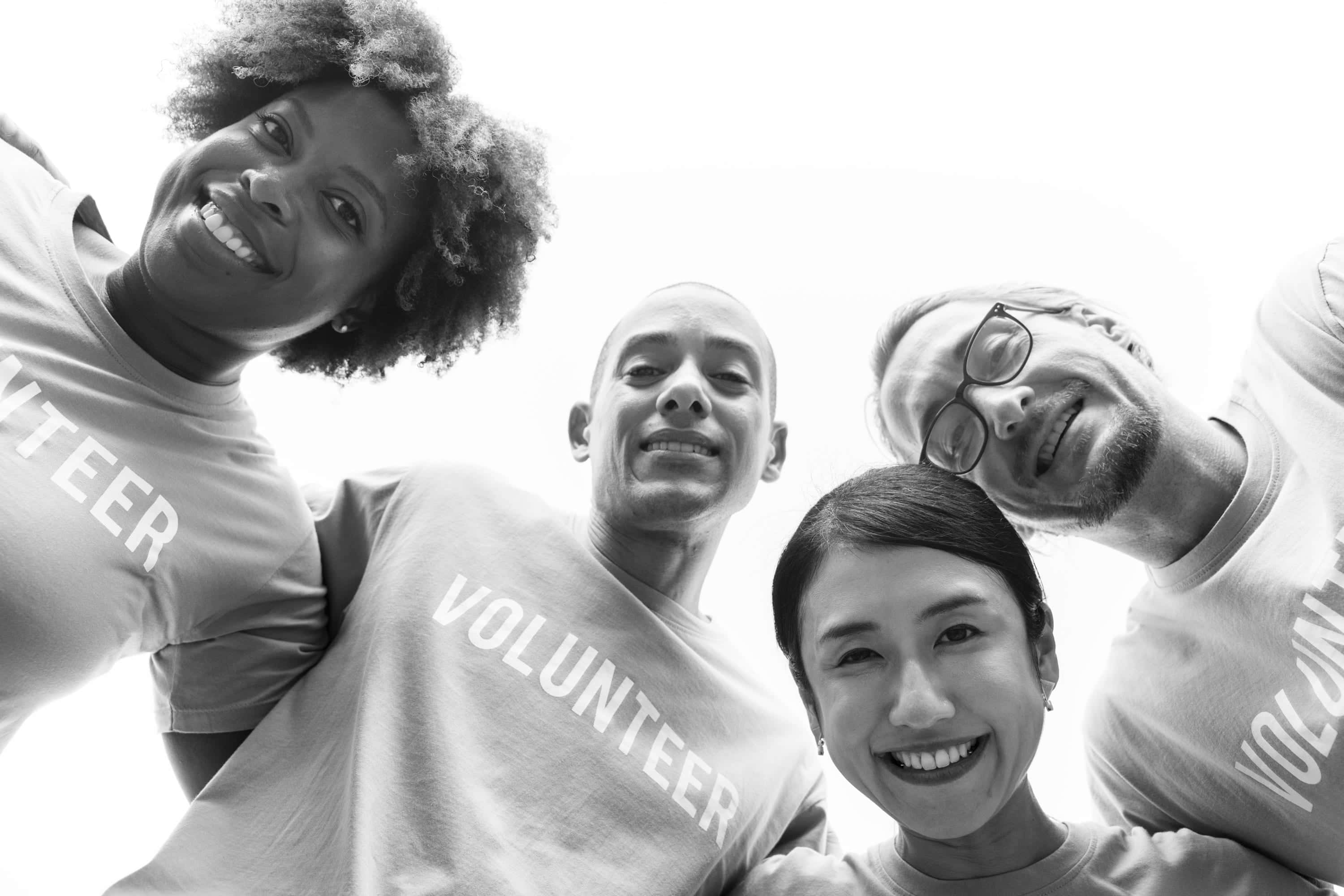 a group of people in t - shirts with the word volunteer Wallpaper