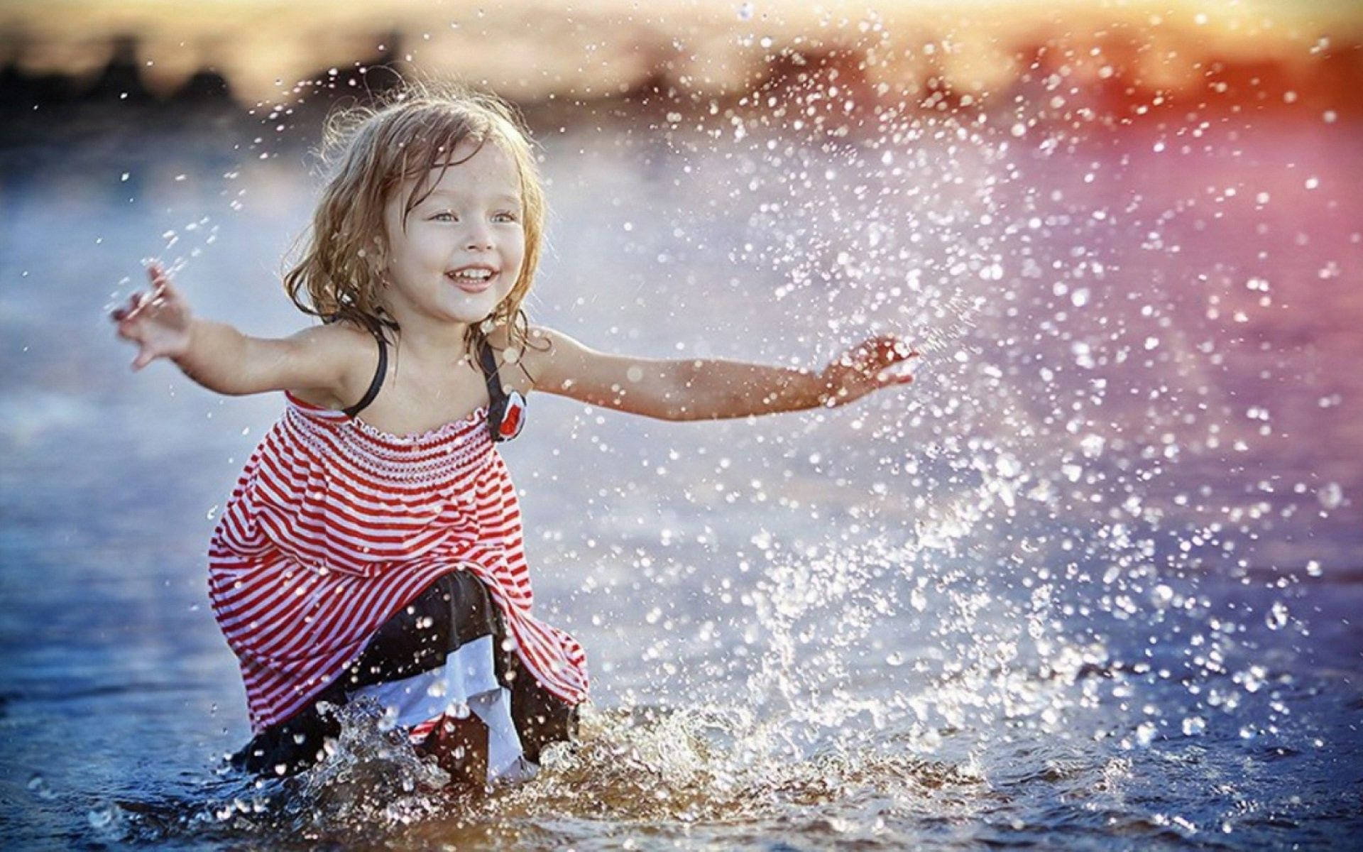 Baby Girl na Naglalaro sa Tubig Wallpaper