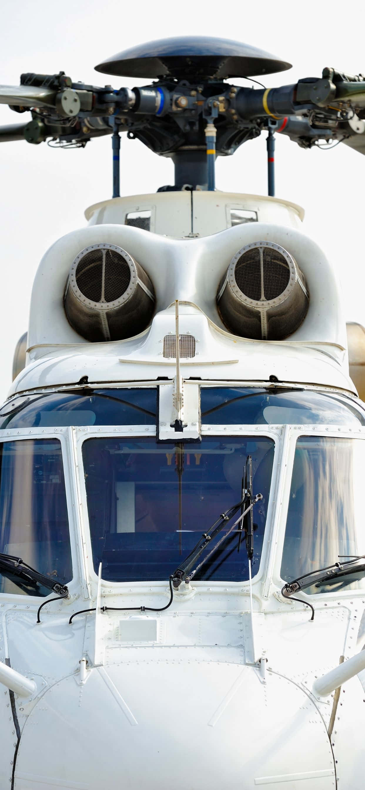 Imahe Mga Maliliwanag na Kulay na mga Helikopter laban sa Isang iPhone XS Max na Asul na Langit na Background Wallpaper