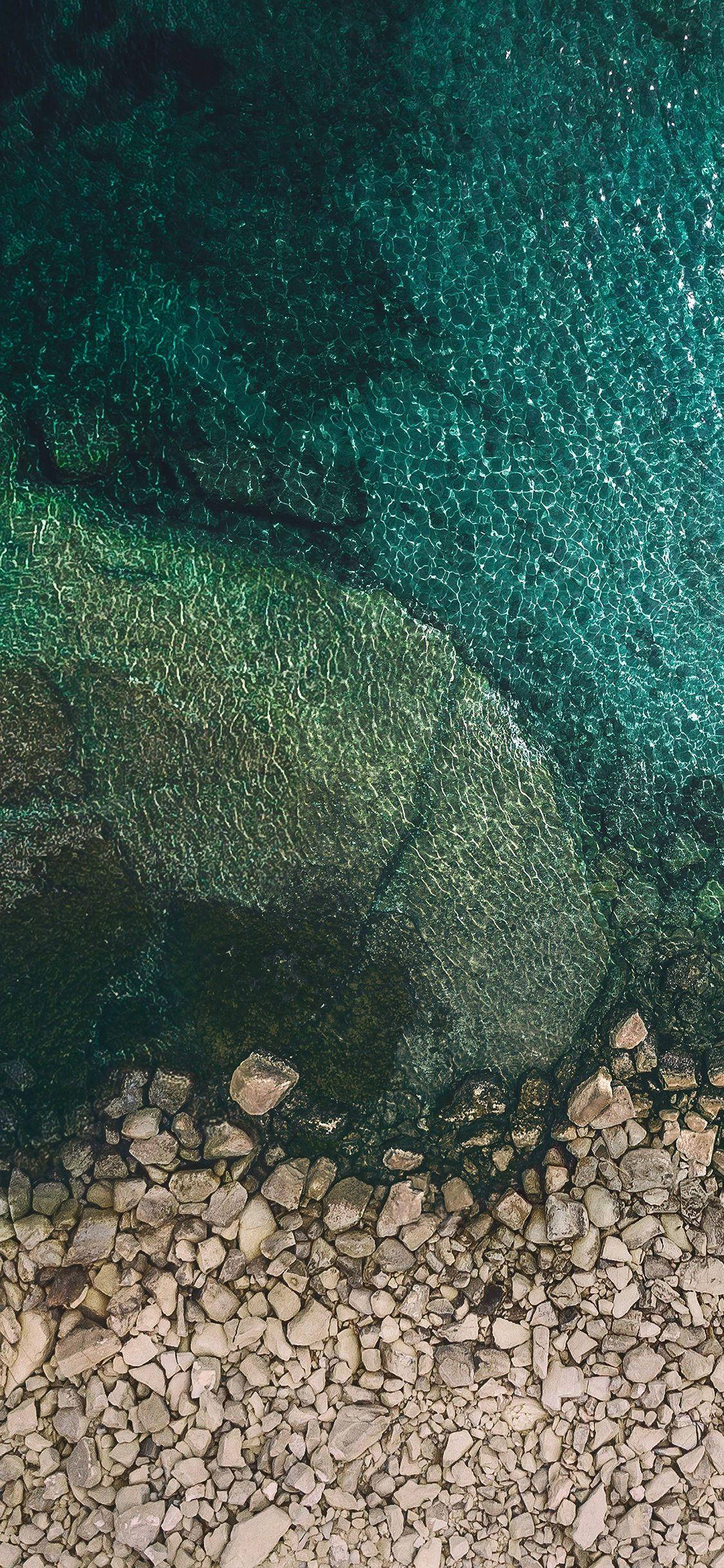 iPhone X Original Pebbles On Seashore Wallpaper