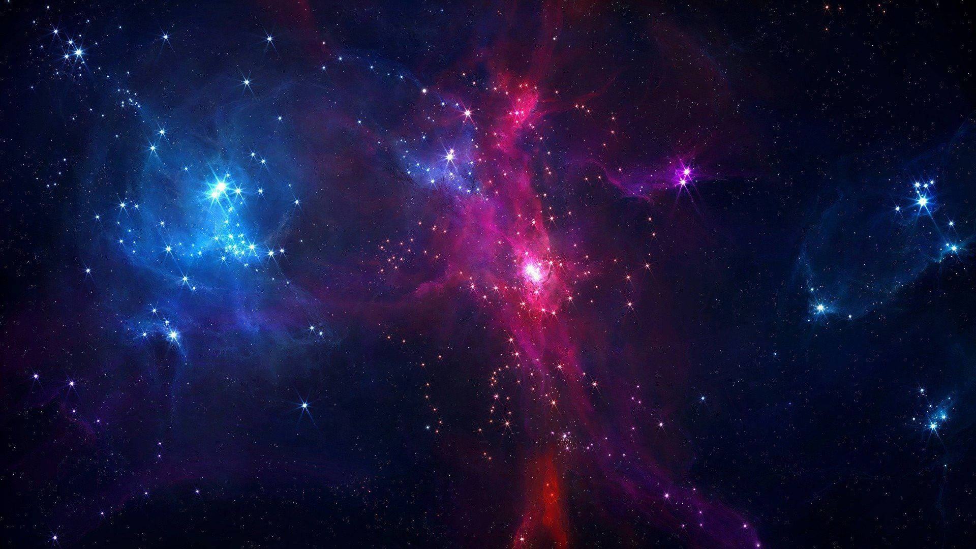 Isang asul at lilang espasyo na may mga bituin at nebula Wallpaper
