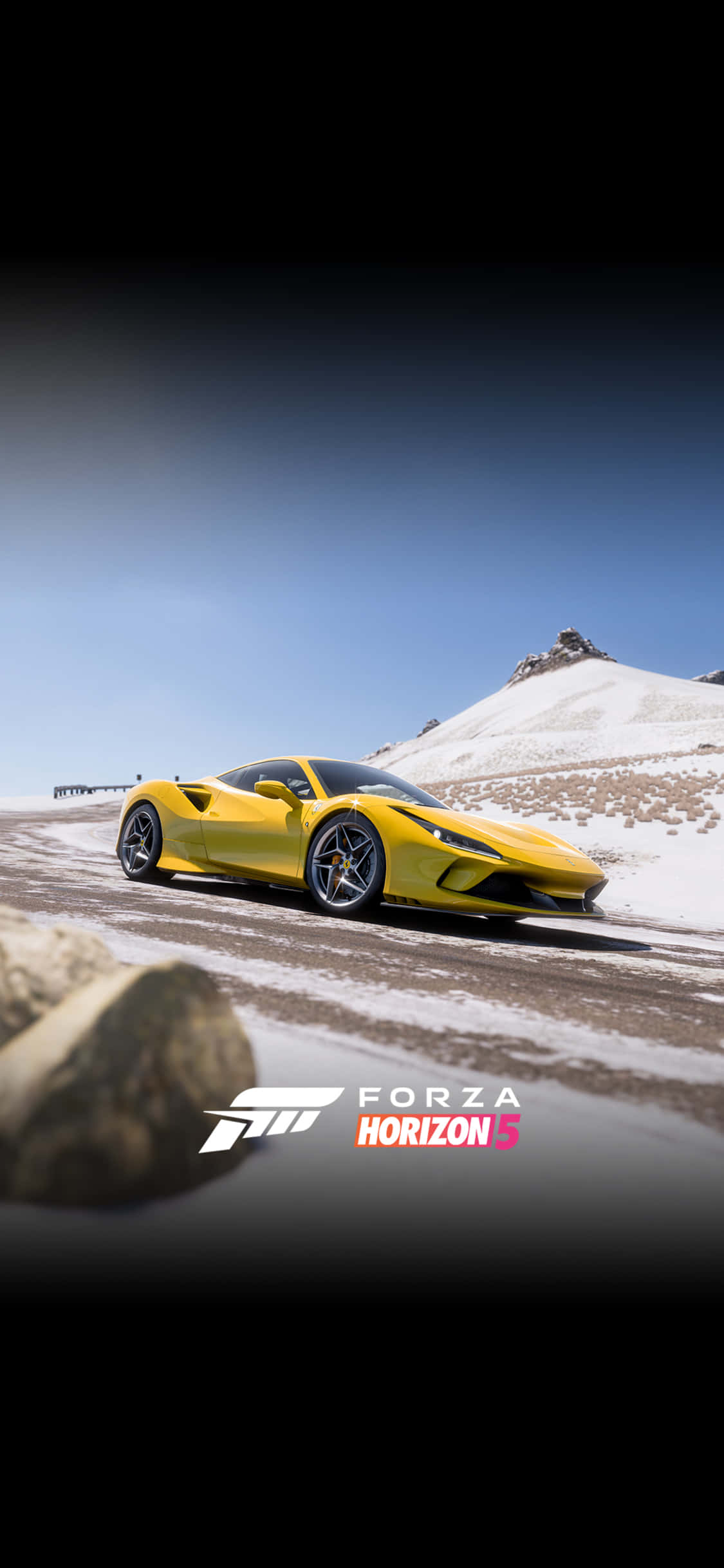 isang dilaw na kotse na nagdadrive sa isang snowy mountain Wallpaper