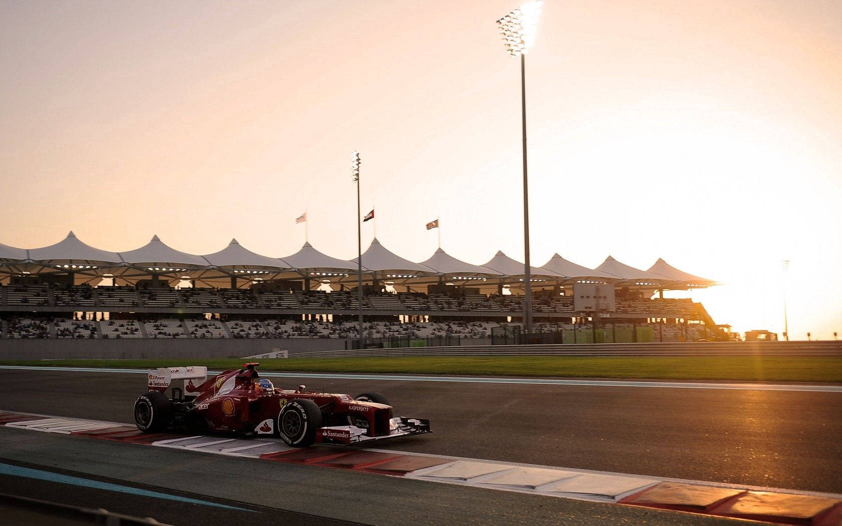 Isang dinamikong tanawin ng isang Ferrari Formula One na kotse sa track Wallpaper