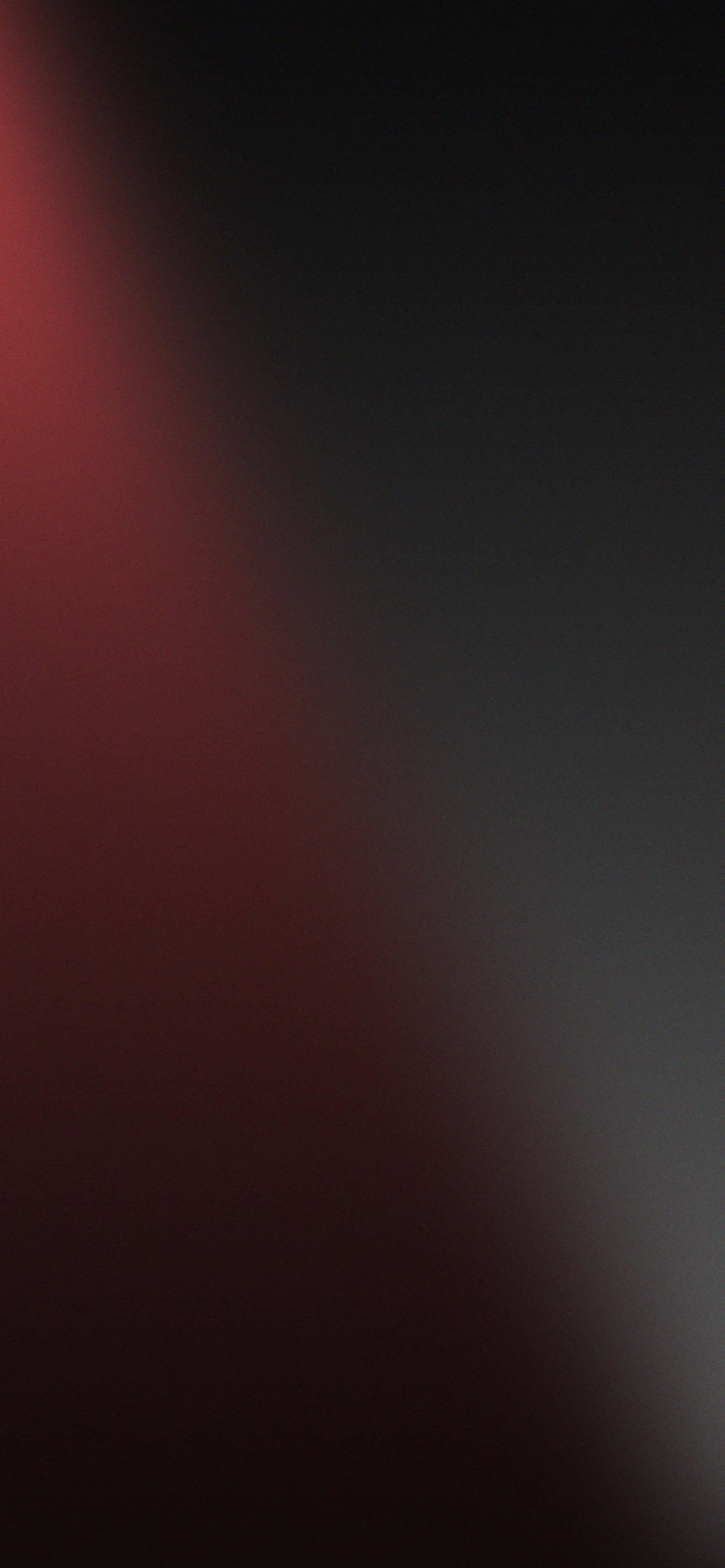 isang itim at pulang na likuran na may liwanag na sumisikat dito Wallpaper