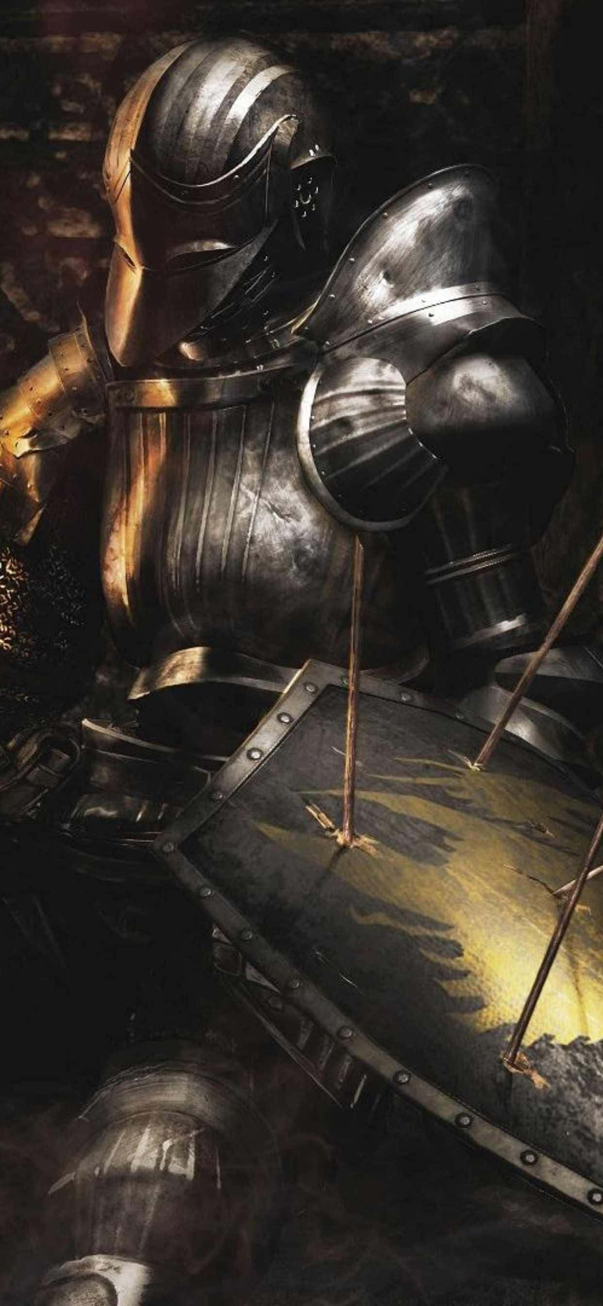 isang kabalyero na nakasuot ng armor ay nakaupo sa madilim na kweba Wallpaper