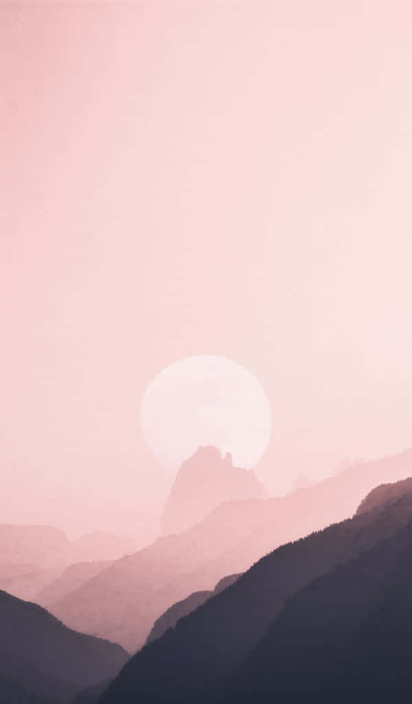 isang kulay rosas na paglubog ng araw sa ibabaw ng mga bundok at burol Wallpaper