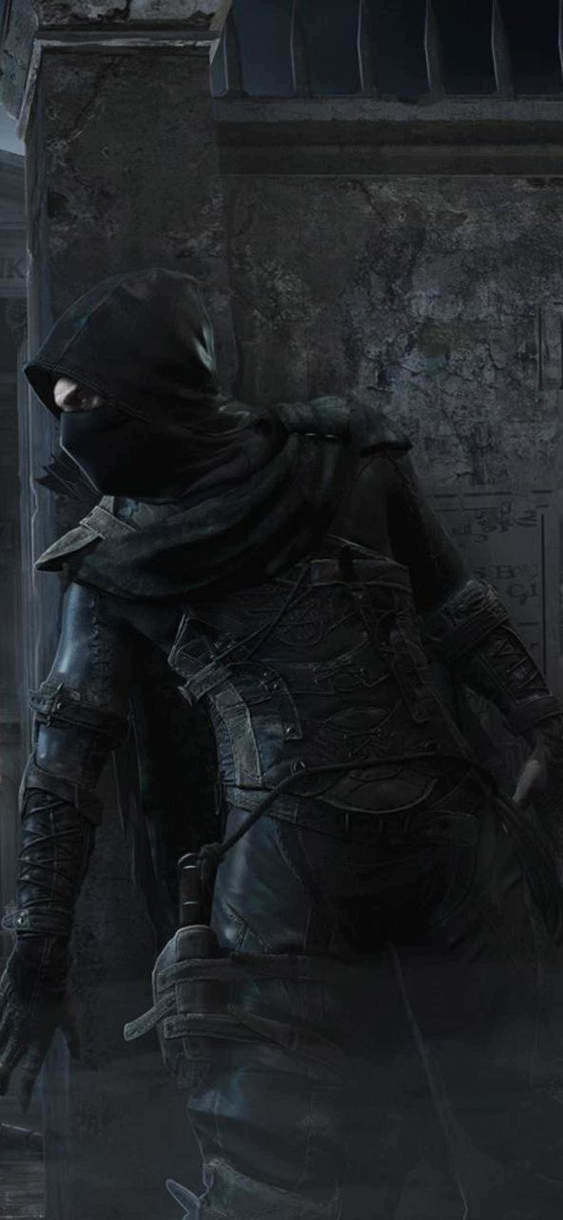 isang lalaki na may hooded robe ay natatayo sa isang madilim na kuwarto Wallpaper