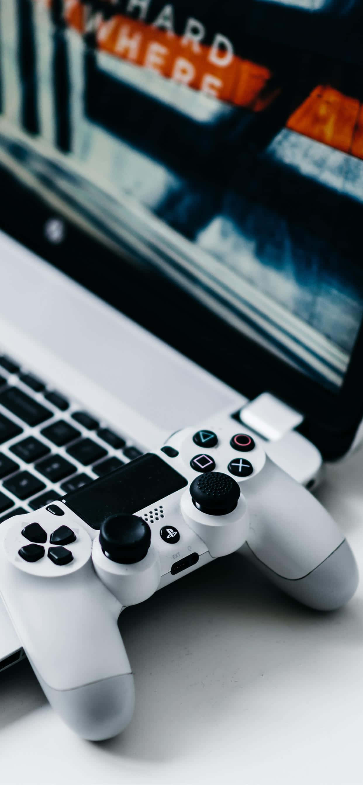 isang laptop computer na may game controller dito Wallpaper