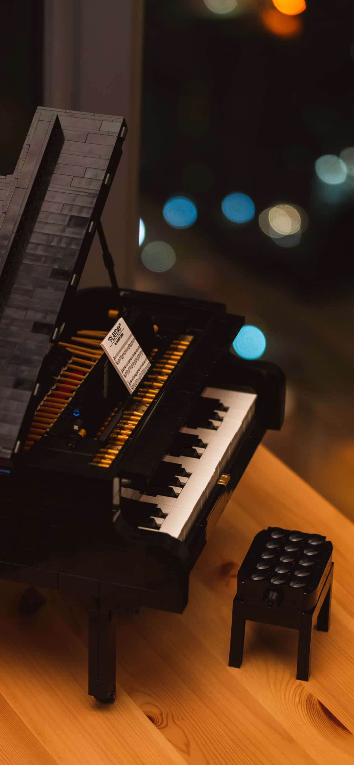 isang lego piano na nakaupo sa mesa na may stool Wallpaper