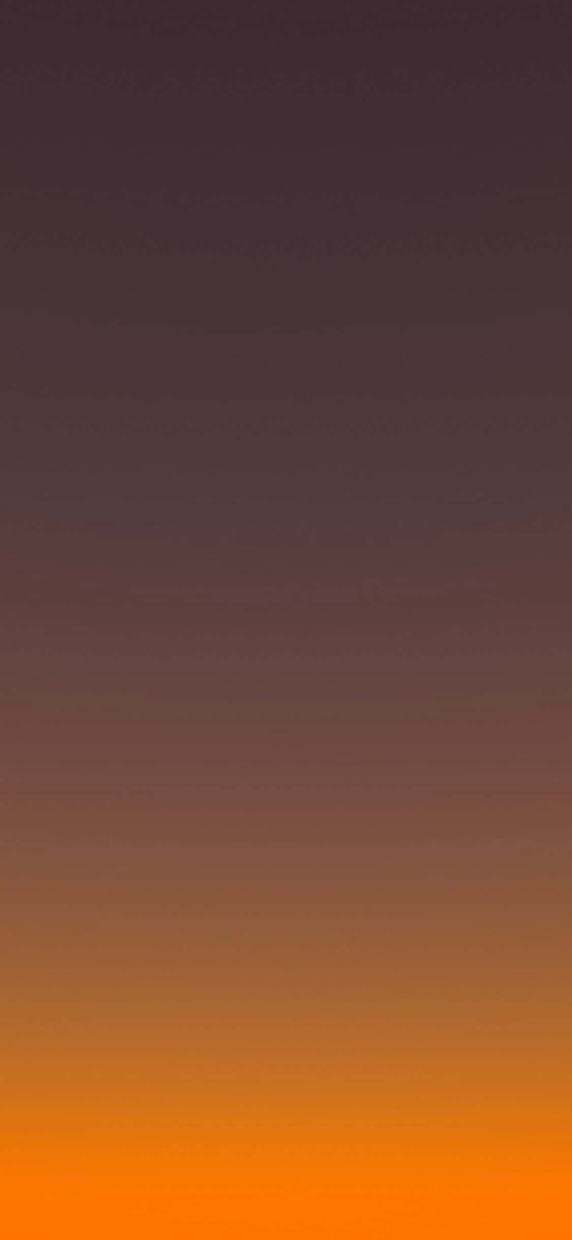 isang orange at dilaw na sunset na may isang bundok sa background Wallpaper