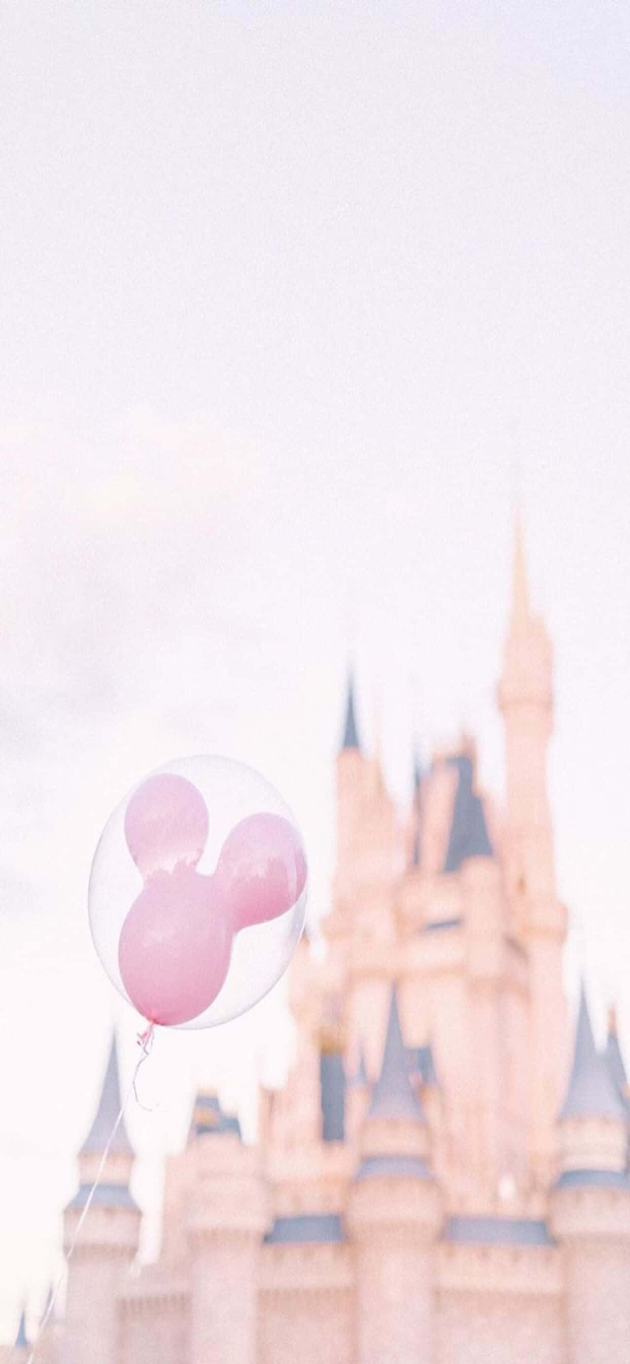 isang pink na balloon ay nasa harap ng isang kastilyo Wallpaper