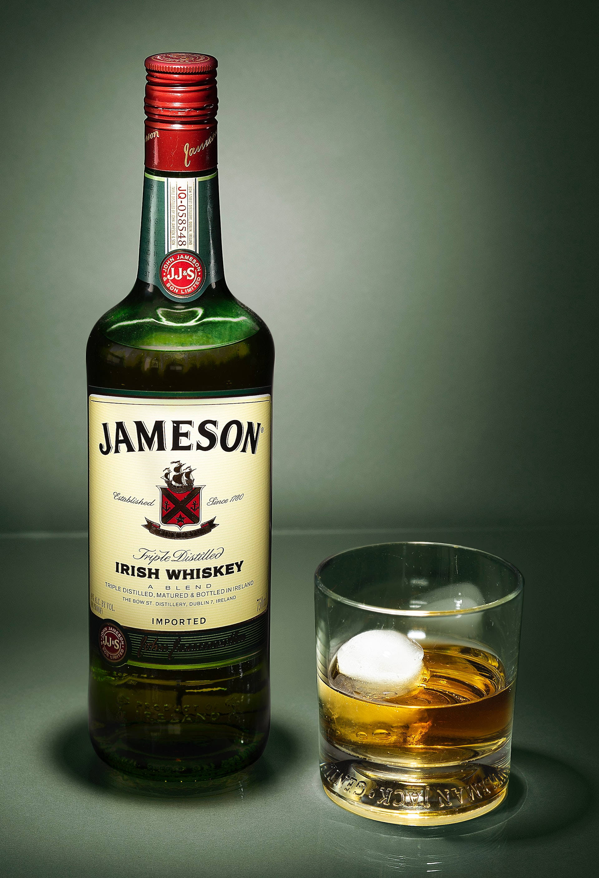 Jameson Whiskey Bottle At Glass Wallpaper