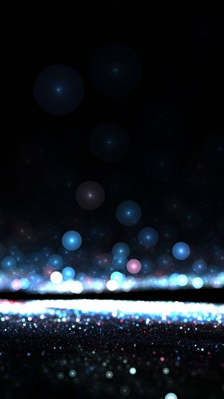 Madilim na Telepono na May Kumikinang na Asul na Orbs Wallpaper