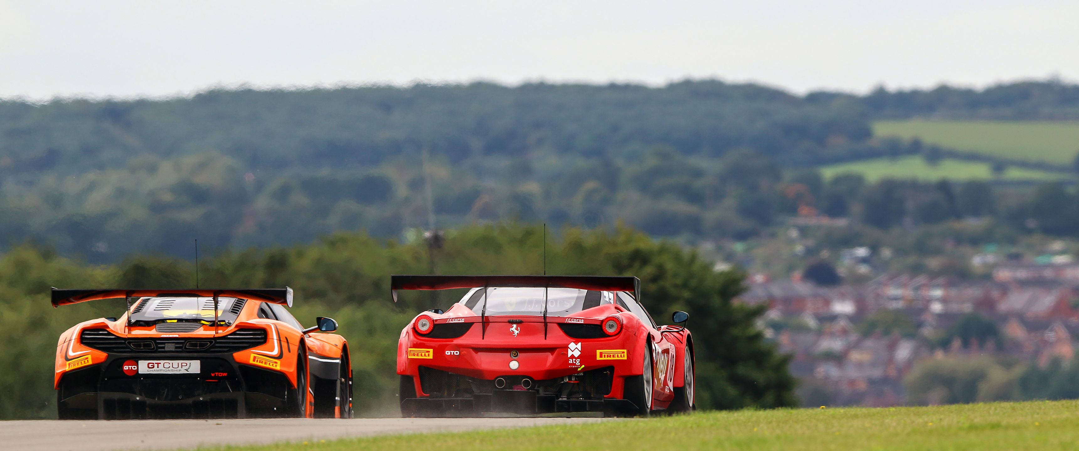Racers Prepare to Battle on a Track Wallpaper