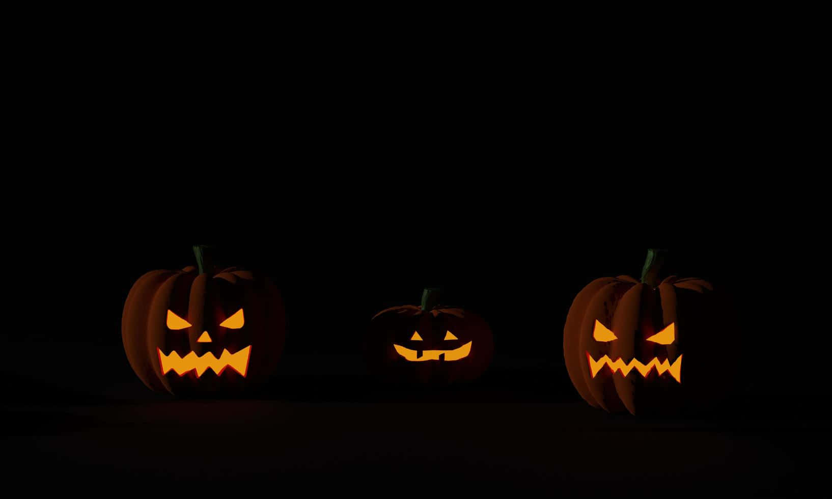 Tatlong Kalabasa sa Halloween na Madilim na Background Wallpaper