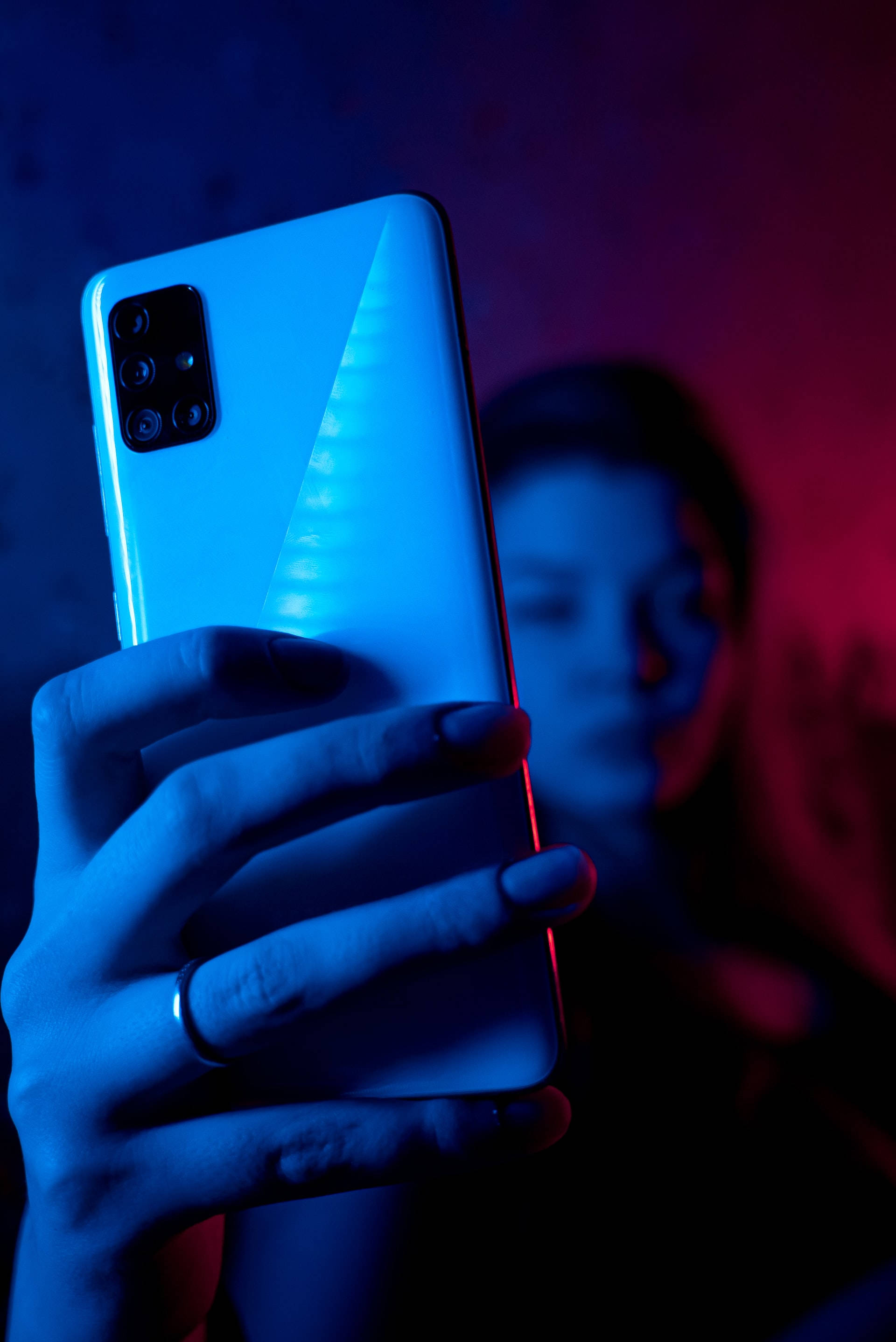 Woman With Phone In Neon Blue iPhone Wallpaper