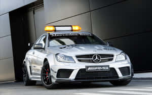 A sleek safety car leading the race on the track — MacBook Pro 13 Wallpaper
