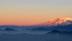 Mountains in snow during sunset wallpaper.