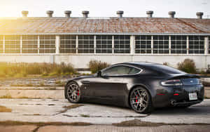 Aston Martin Vanquish na Gumagalaw sa Isang Nakakikilng na Daan — 2880x1800 Wallpaper