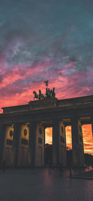 Brandenburg Gate Quadriga Orange Pink Sky — iPhone 17 Pro Max Wallpaper