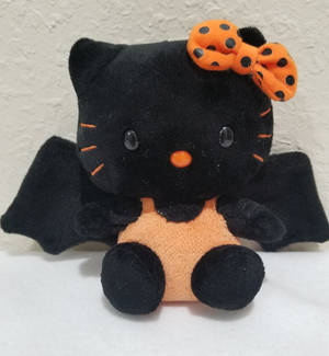 Orange-itim na bat Hello Kitty Halloween wallpaper