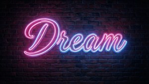 Neon sign na 'Dream' na kulay pink at asul sa madilim na ladrilyo para sa amoled
