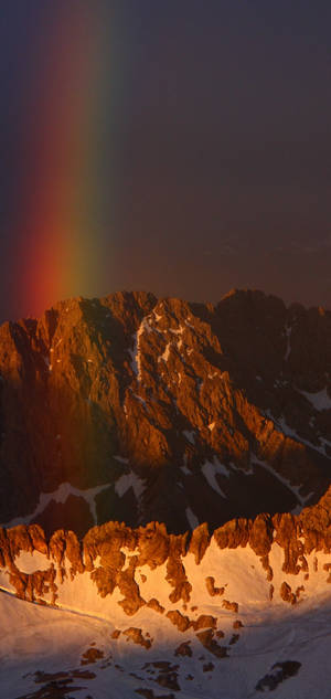 S10 rainbow on snow mountain wallpaper. — iPhone 17 Wallpaper