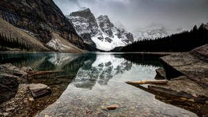 Clear waters of the lake and snow covered mountains wallpaper.