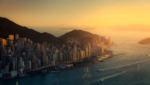 Magandang Hong Kong cityscape na may paglubog ng araw na wallpaper.